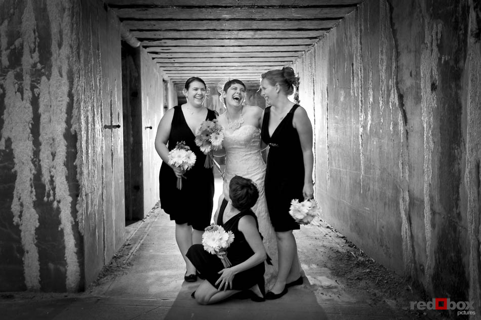 The bride and her bridesmaids laugh it up at Fort Casey State Park on Whidbey Island following the wedding. (Photography by Scott Eklund/Red Box Pictures/Seattle)