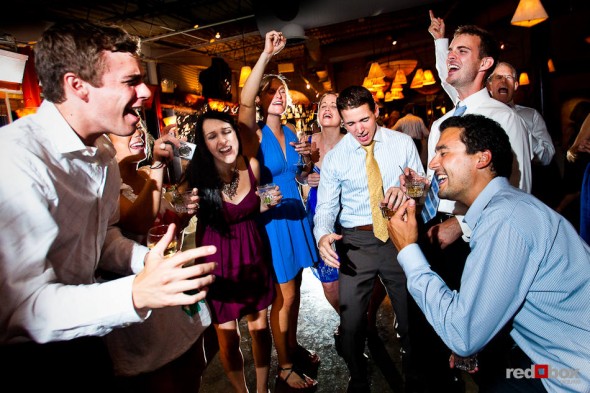 Guests of Anghi and Andy's wedding singalong during the couple's reception at The Canal in Seattle's Ballard neighborhood. (Photo by Dan DeLong/Red Box Pictures)