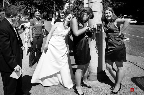 Katherine has a laugh with her wedding party while walking back to after a photography session at Freeway Park in Seattle. (Photo by Dan DeLong/Red Box Pictures)