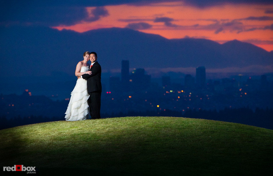 Jenny and Eugene stand near the 18th green during sunset after their wedding at The Golf Club at Newcastle. (Photo by Andy Rogers/Red Box Pictures)