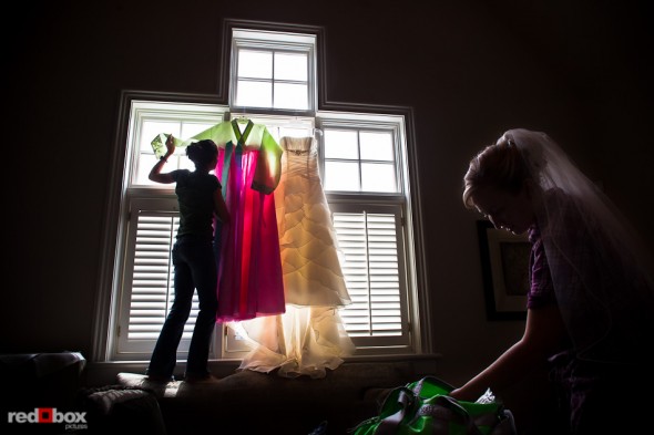 A bridesmaid hangs Jenny's traditional Korean wedding dress next to her Western-style dress as she gets ready for her wedding ceremony at The Golf Club at Newcastle. (Photo by Andy Rogers/Red Box Pictures)