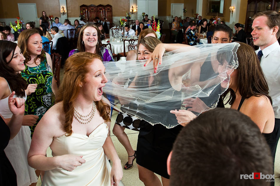 Katherine's veil gets tangled with her sister as they dance with guests during their wedding reception at the Women's University Club in Seattle. (Photo by Dan DeLong/Red Box Pictures)