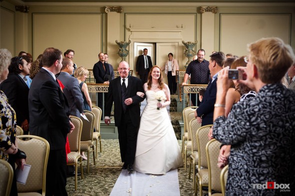 Bride Katherine and her father walk down the aisle of the ballroom at the Women's University Club in Seattle. (Photo by Dan DeLong/Red Box Pictures)