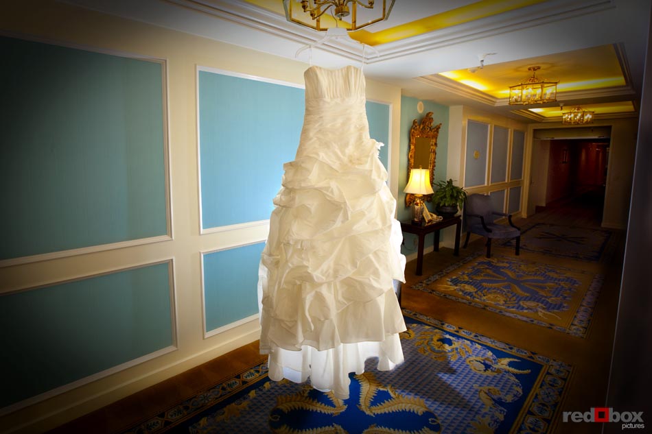 The wedding dress hangs at the Fairmont Olympic Hotel in Seattle, before the wedding at the Top of the Market at the Pike Place Market in Seattle. Wedding Photographer Scott Eklund/Red Box Pictures-Seattle
