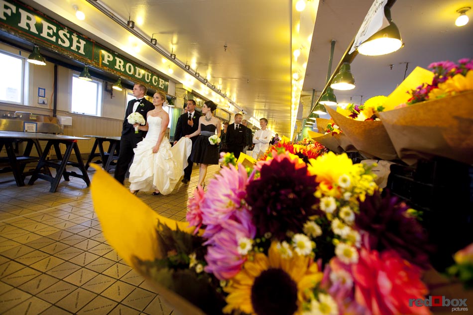 The bride & groom stroll through Pike Place Market in Seattle with their bridal party, prior to their wedding at the Top of the Market. Seattle-Wedding Photographer-Scott Eklund-Red Box Pictures