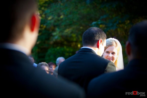 The bride and groom look into each others eyes at the alter during their wedding at The Hall at Fauntleroy in Seattle, Washington. Seattle Wedding Photographer Scott Eklund Red Box Pictures