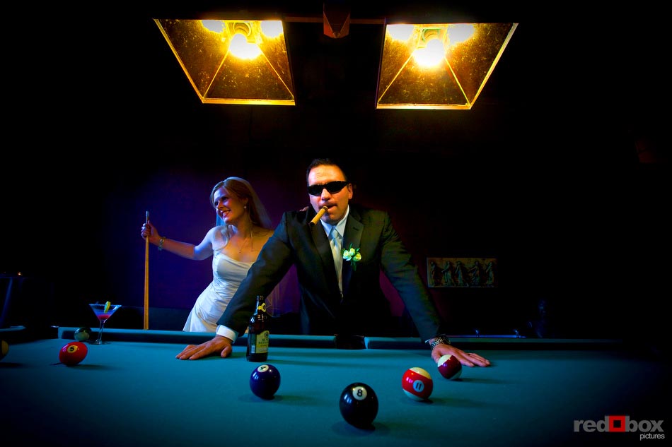 The bride & groom at the pool table at The Hall at Fauntleroy in West Seattle, Washington. (Wedding Photography By Scott Eklund Red Box Pictures Seattle)