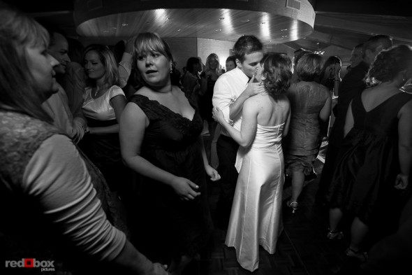 Lisa and Alex kiss on the dance floor during the wedding reception at the Edgewater Hotel. (Photo by Andy Rogers/Red Box Pictures)