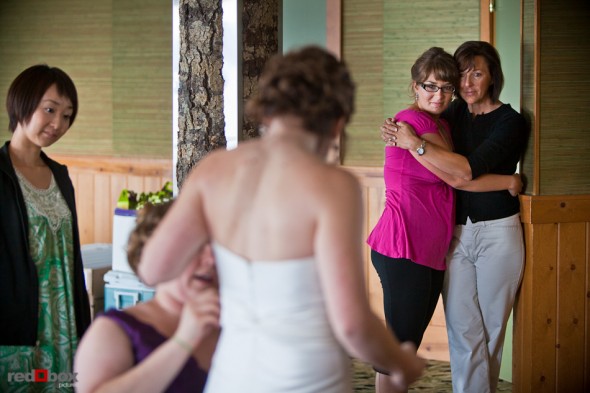 Lisa has adjustments made to her dress as Alex's mother and sister-in-law-to-be look on prior to their wedding at the Edgewater Hotel. (Photo by Andy Rogers/Red Box Pictures)