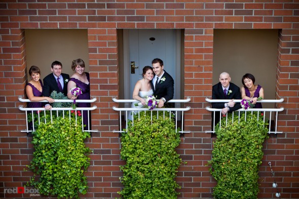 Lisa and Alex pose with their wedding party at the Inn at the Market, where they became engaged, prior to their wedding at the Edgewater Hotel. (Photo by Andy Rogers/Red Box Pictures)