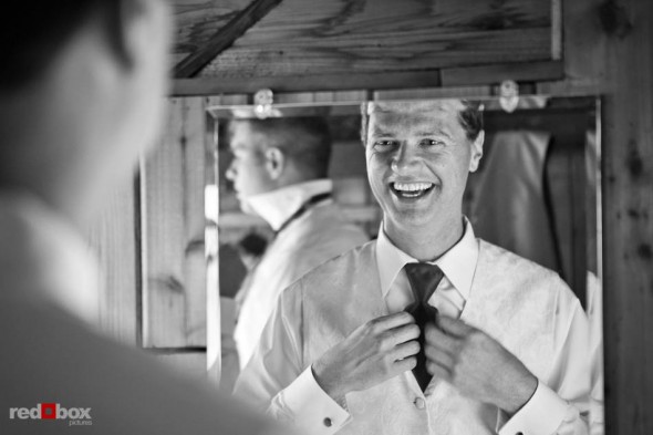Michael adjusts his tie before his wedding with Suzy at Kiana Lodge near Bainbridge Island, WA. (Photo by Andy Rogers/Red Box Pictures)
