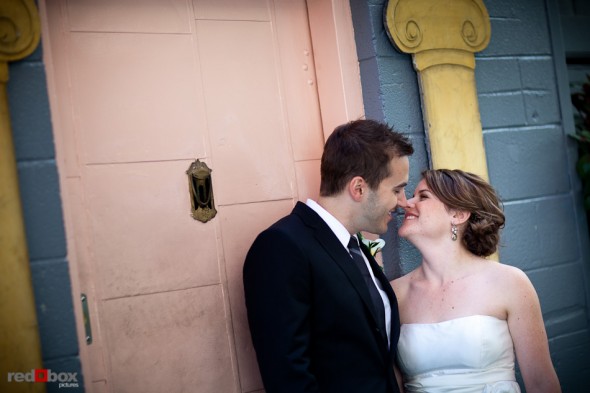 Lisa and Alex stand outside The Pink Door, where their rehearsal dinner was held, prior to their wedding at the Edgewater Hotel. (Photo by Andy Rogers/Red Box Pictures)