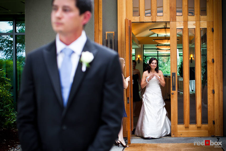 Nadine approaches her future husband, Brian, for their "first look', or reveal, outside The Plateau Club in Sammamish, WA. (Photo by Dan DeLong/Red Box Pictures)