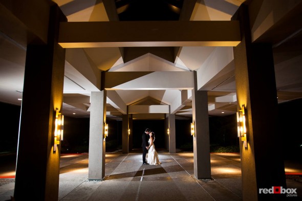 Outside the Plateau Club in Sammamish, WA, Brian and Nadine kiss under the venue's entryway. (Photo by Dan DeLong/Red Box Pictures)