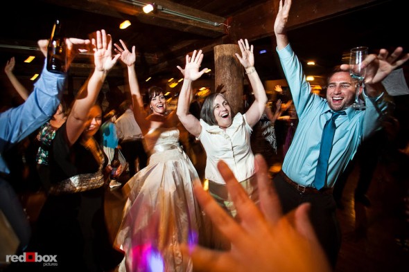 The bride and guests dance to the music at Suzy and Michael's wedding reception at Kiana Lodge in Poulsbo, WA. (Photo by Dan DeLong/Red Box Pictures)