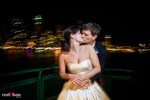 With the Seattle skyline behind them, Suzy and Michael kiss while returning to the city aboard a ferry after their wedding at Kiana Lodge near Bainbridge Island. (Photo by Dan DeLong/Red Box Pictures)