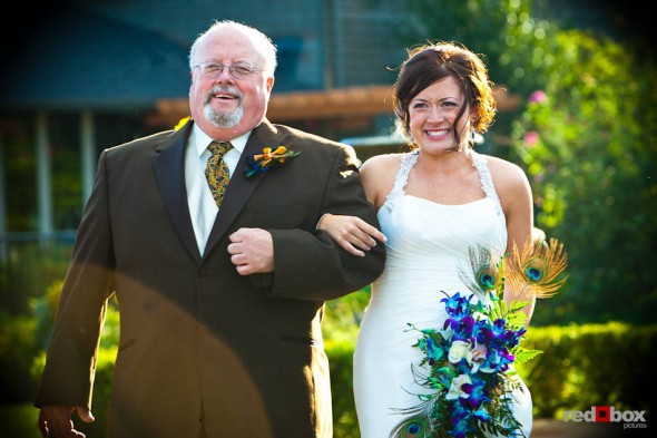 Liz becomes emotional while walking down the aisle with her father during her outdoor wedding ceremony at Hidden Meadows in Snohomish, WA. (Photo by Dan DeLong/Red Box Pictures)