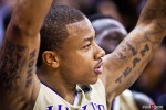 Washington Huskies' Isaiah Thomas displays his tattoos while cheering on teammates from the bench during the men's basketball season opener against McNeese State at UW's Hec Edmundson Pavilion. (Photo by Dan DeLong/Red Box Pictures)