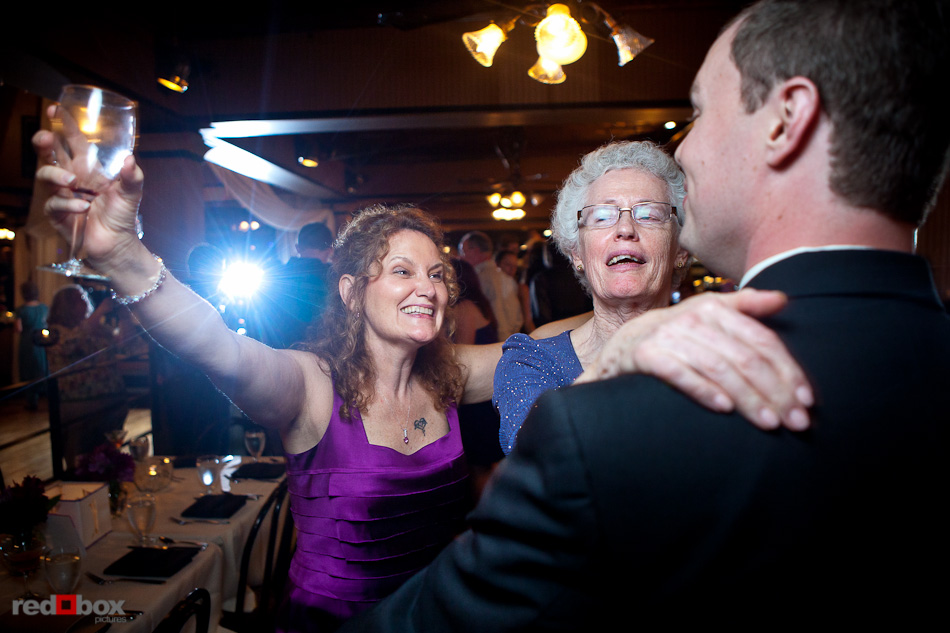 Nick is greeted by guests during their wedding reception at the Lake Union Cafe in Seattle. (Photography by Andy Rogers/Red Box Pictures)