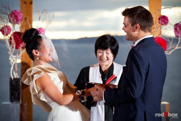 Angie and Jordan laugh during their wedding ceremony at the Edgewater Hotel in Seattle. (Photo by Dan DeLong/Red Box Pictures)