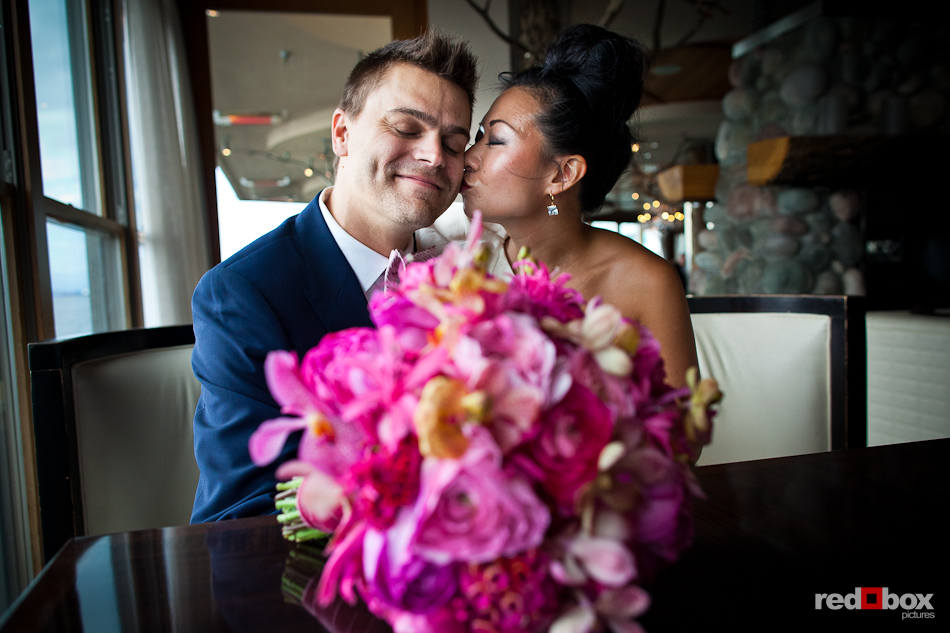 Angie plants a kiss Jordan after their first look on their wedding day at the Edgewater Hotel in Seattle. (Photo by Dan DeLong/Red Box Pictures)