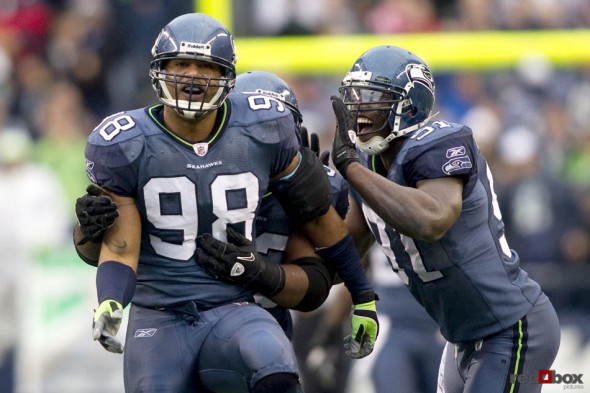 Raheem Brock (98) celebrates a fourth quarter sack with Chris Clemons as the Seattle Seahawks beat the Carolina Panthers 31-14 at Qwest Field in Seattle on Sunday December 5, 2010. (Seattle Sports Photography By Scott Eklund/Red Box Pictures)