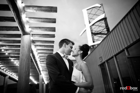 After their wedding ceremony, Jordan and Angie kiss under the giant E sign that's atop the Edgewater Hotel in Seattle. (Photo by Dan DeLong/Red Box Pictures)