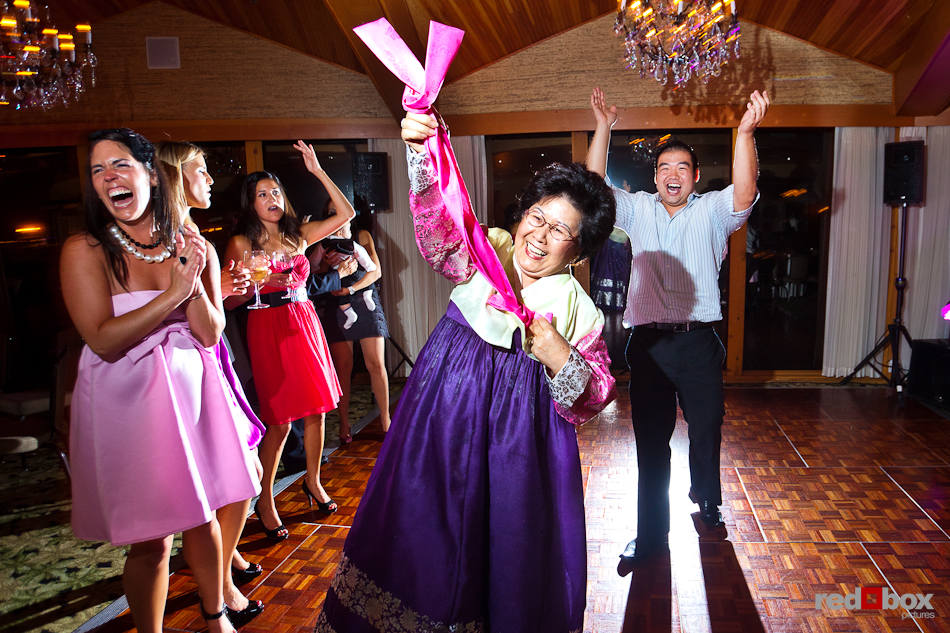 Guests, including the bride's mother, dance during Angie and Jordan's rocking wedding reception at the Edgewater Hotel in Seattle. (Photo by Dan DeLong/Red Box Pictures)