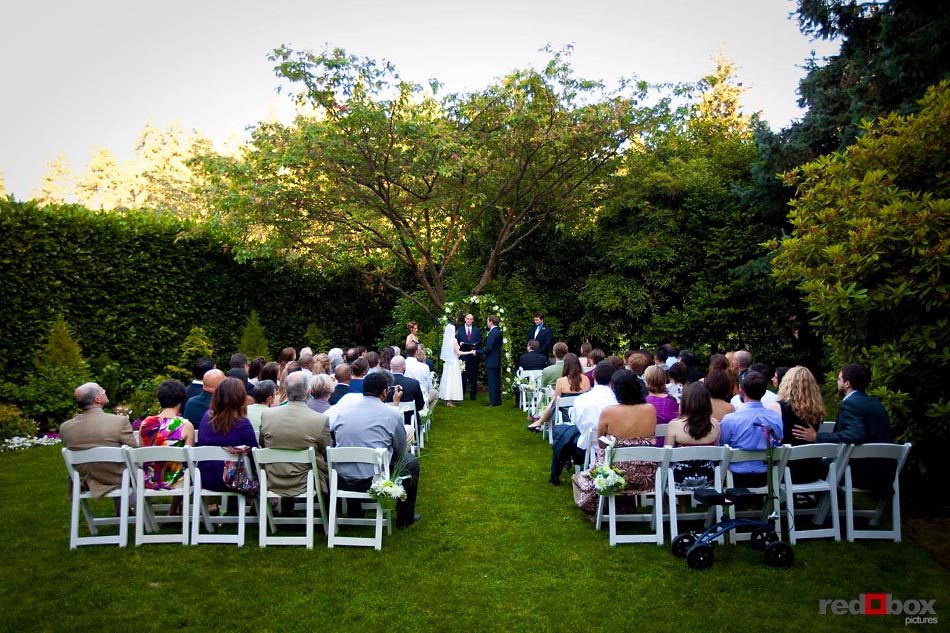 The bride and groom, Susan & Mark, exchange vows at their wedding ceremony at the Robinswood House in Bellevue, Washington. Seattle Wedding Photographer Scott Eklund Red Box Pictures