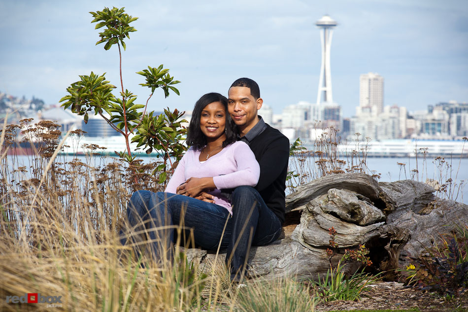 Nick and Tia sit at Seacrest Park in West Seattle for their engagement portrait session. (Photography by Andy Rogers/Red Box Pictures)