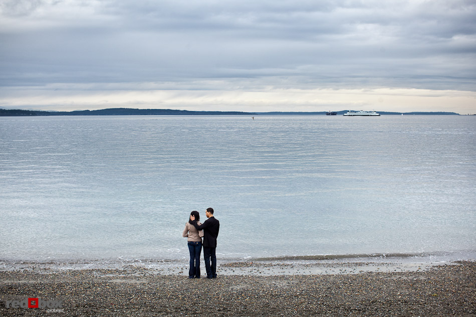 Nick and Tia watch a passing ferry from Alki Beach in West Seattle for their engagement photo session. (Photography by Dan DeLong/Red Box Pictures)