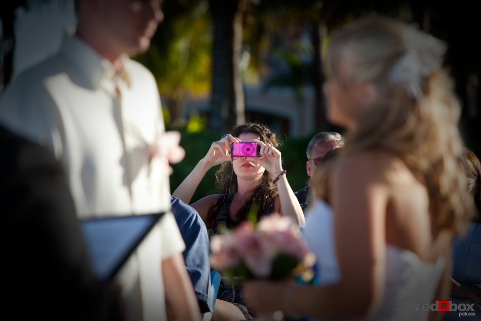 A friend snaps a picture during the wedding of Tasha & Jeff at their wedding at the Old Bay Bahama Resort in the Bahamas. (Wedding Photography by Scott Eklund/Red Box Pictures)