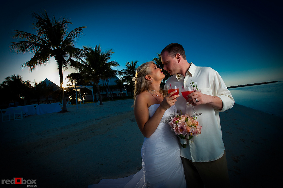 The bride & groom drink Bahama Mamas at the Old Bay Bahama Resort in the Bahamas. (Wedding Photography by Scott Eklund/Red Box Pictures)