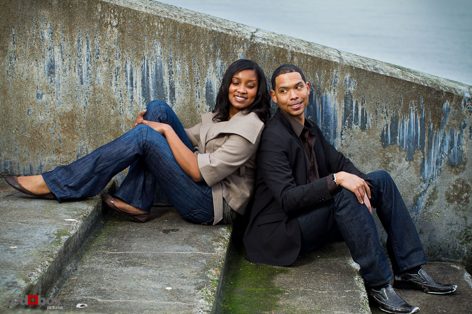 During their engagement portrait session, Nick and Tia sit on the stairs to Alki Beach in West Seattle. (Photography by Andy Rogers/Red Box Pictures)