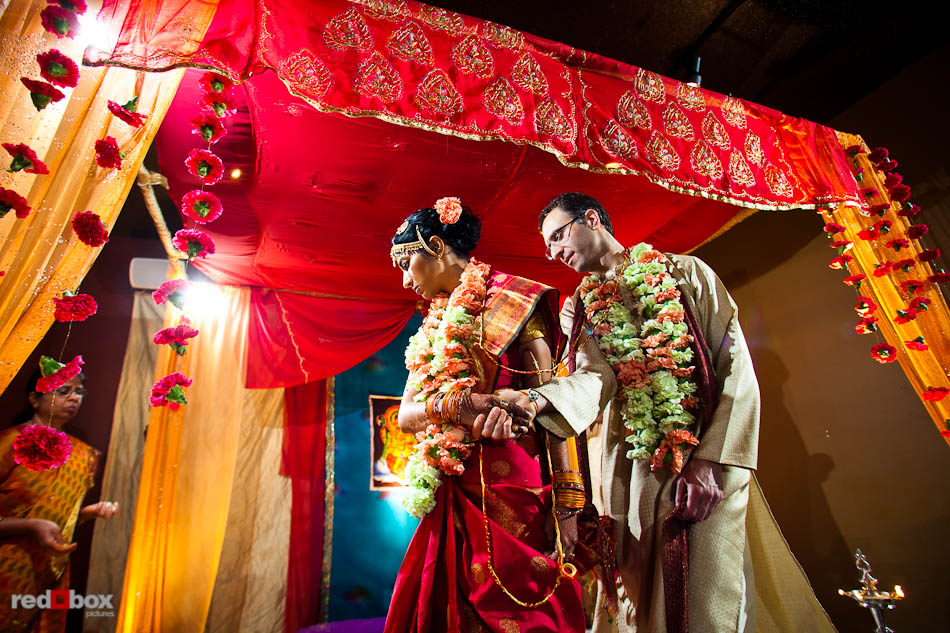 Karthik and Mike circle during their Indian wedding ceremony at the Seattle wedding venue the Uptown Hideaway. (Photo by Dan DeLong/Red Box Pictures)
