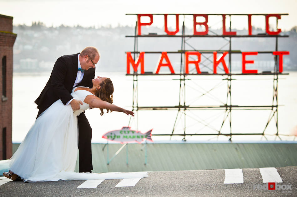 Katie and Bryce strike a wedding day pose at Seattle's famous Pike Place Market. (Photo by Dan DeLong/Red Box Pictures)