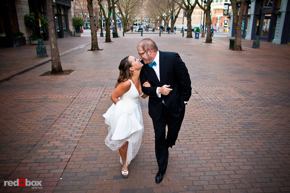 Katie and Bryce stroll through Occidental Park in Pioneer Square in Seattle on the day of their wedding reception. (Photo by Dan DeLong/Red Box Pictures)