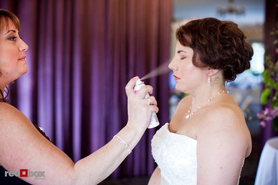 Kari's sister and matron of honor adds a last bit of hairspray at Courtyard Hall in Bothell. (Photo by Andy Rogers/Red Box Pictures)