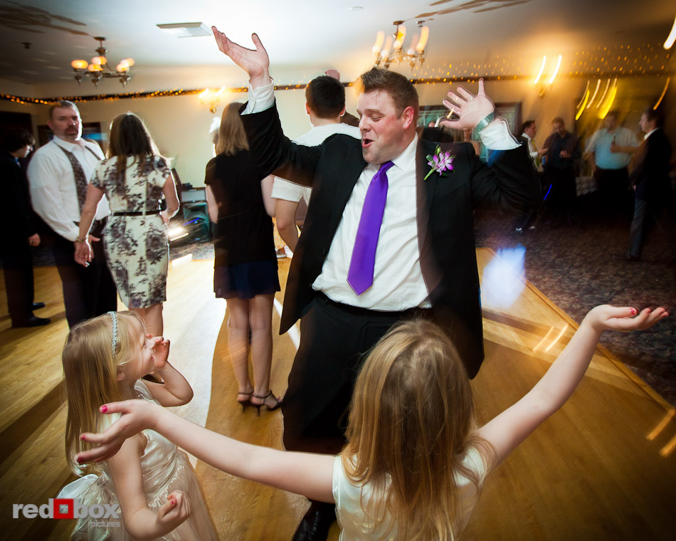 Matt shows off his moves as the flower girls look on during his wedding reception at Courtyard Hall in Bothell. (Photo by Andy Rogers/Red Box Pictures)