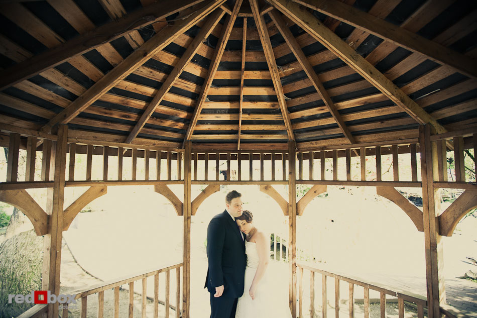 Kari and Matt stand under the gazebo in the Country Village prior to their wedding at Courtyard Hall in Bothell. (Photo by Andy Rogers/Red Box Pictures)