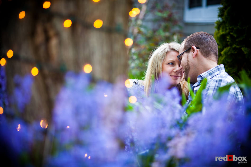Megan and Tyler share a moment in an Edmonds, WA garden. The couple was being photographed to celebrate their recent engagement. (Photo by Dan DeLong/Red Box Pictures)