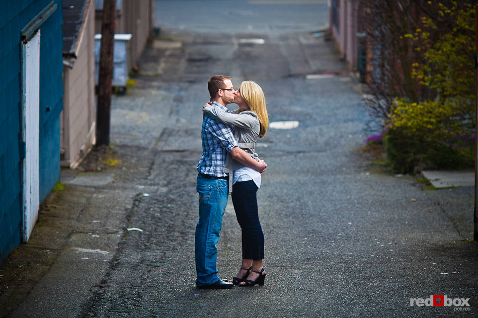 Megan and Tyler kiss in an alley in Edmonds, WA. The couple was being photographed to celebrate their recent engagement. (Photo by Dan DeLong/Red Box Pictures)