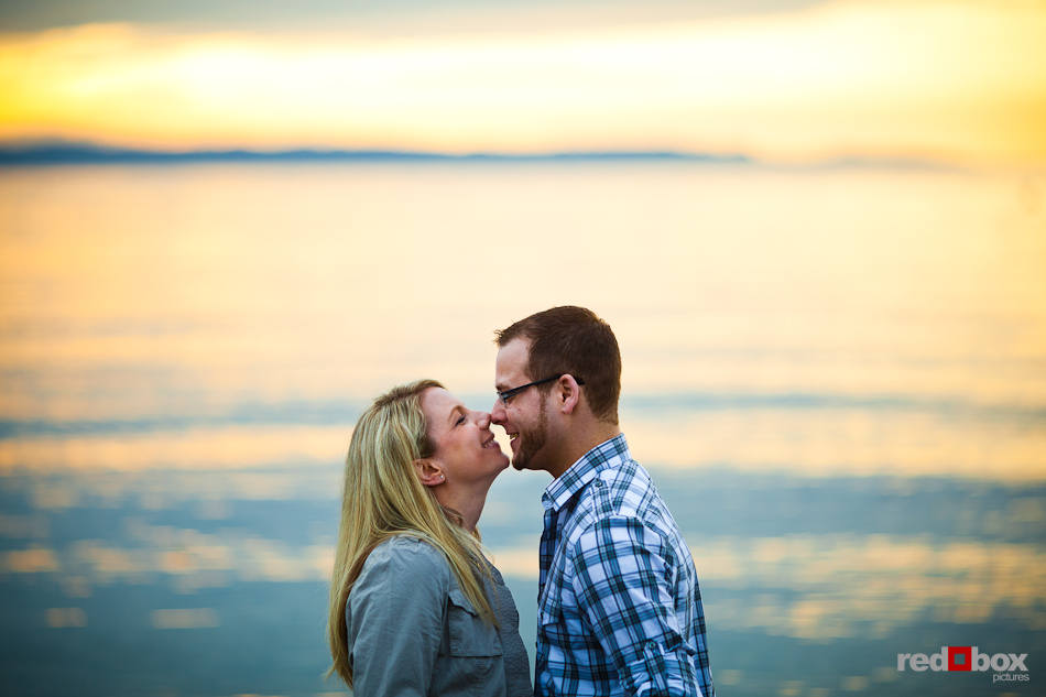 During their engagement pictures, Megan and Tyler kiss on the waterfront in Edmonds, WA. (Photo by Dan DeLong/Red Box Pictures)