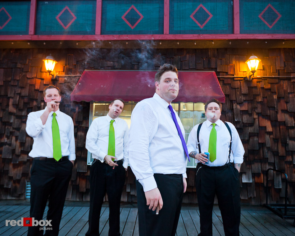 Matt puffs on a celebratory cigar with his groomsmen during his wedding reception at Courtyard Hall in Bothell. (Photo by Andy Rogers/Red Box Pictures)