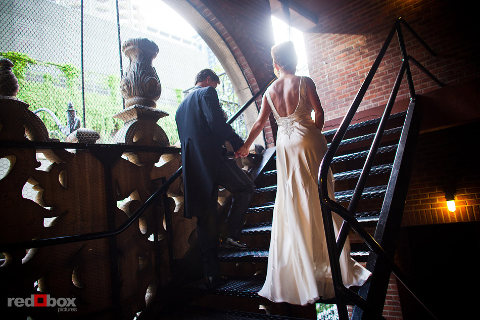 Summer and Jeff walk to a fire escape outside The Paramount Theater right after their wedding ceremony in Seattle. (Photo by Andy Rogers/Red Box Pictures)
