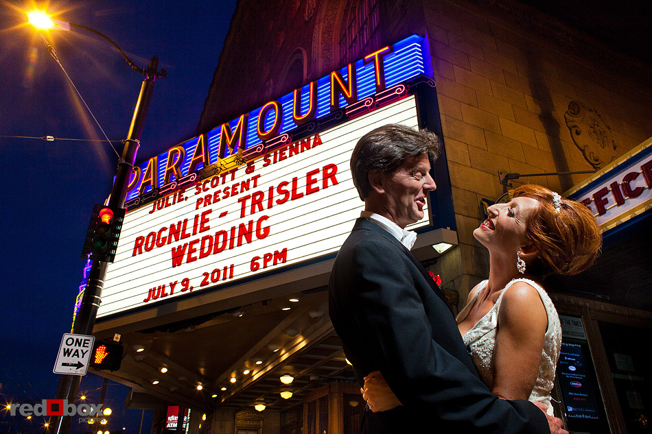 Summer and Jeff embrace in front of The Paramount Theater marquee bearing their names during their wedding in Seattle. (Photo by Andy Rogers/Red Box Pictures)