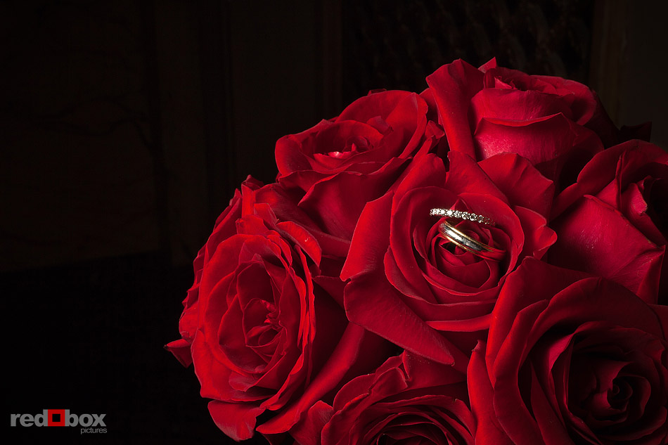 Summer's red rose bouquet is a temporary seat for the couple's wedding bands at The Paramount Theater in Seattle. (Photo by Andy Rogers/Red Box Pictures)
