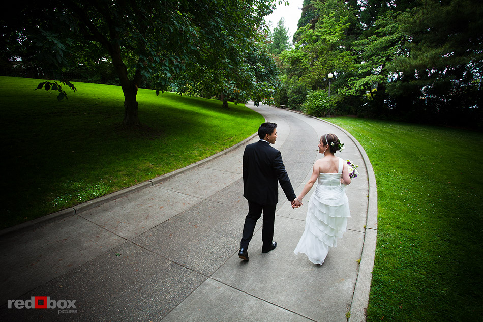 Laura and Ted walk at the Ballard Locks park prior to their wedding at Ray's Boathouse in Seattle. (Photo by Andy Rogers/Red Box Pictures)