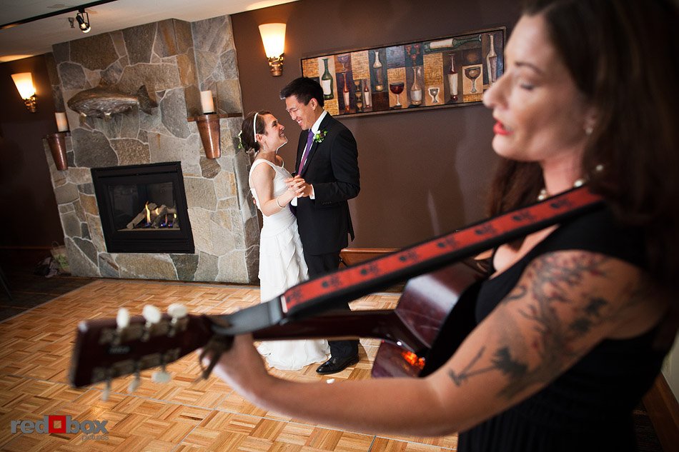 Ted and Laura enjoy their first dance as a friend plays the guitar during their wedding in the Northwest Room at Ray's Boathouse in Seattle. (Photo by Andy Rogers/Red Box Pictures)