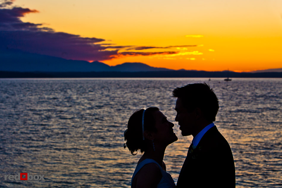 Laura and Ted take a solitary moment during sunset at their Ray's Boathouse wedding in Seattle. (Photo by Andy Rogers/Red Box Pictures)